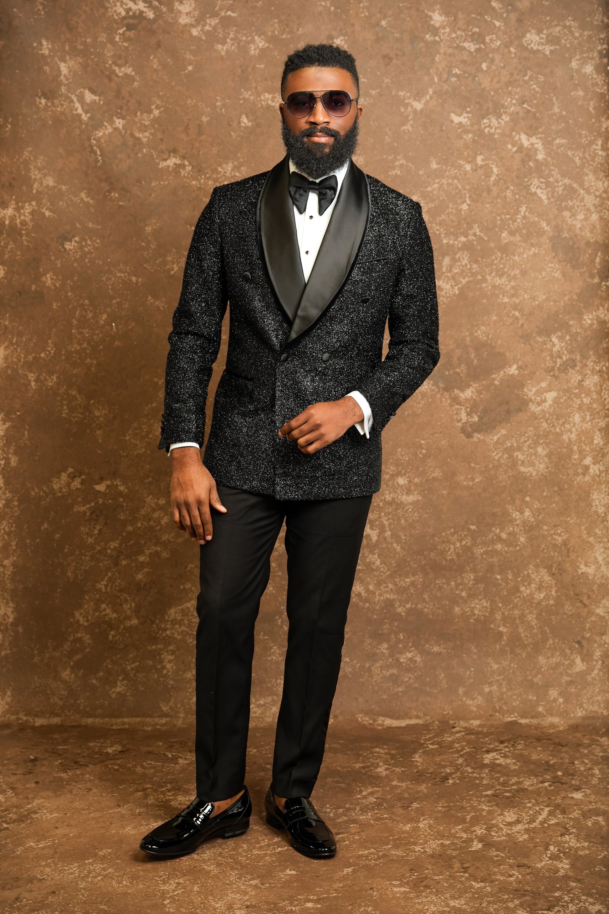 Man wearing a black tuxedo with a white Tuxedo shirt and black bow tie