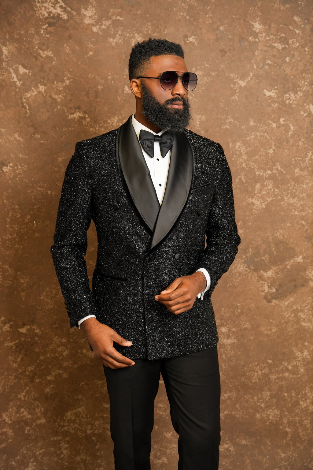 Man wearing a black tuxedo with a white Tuxedo shirt and black bow tie