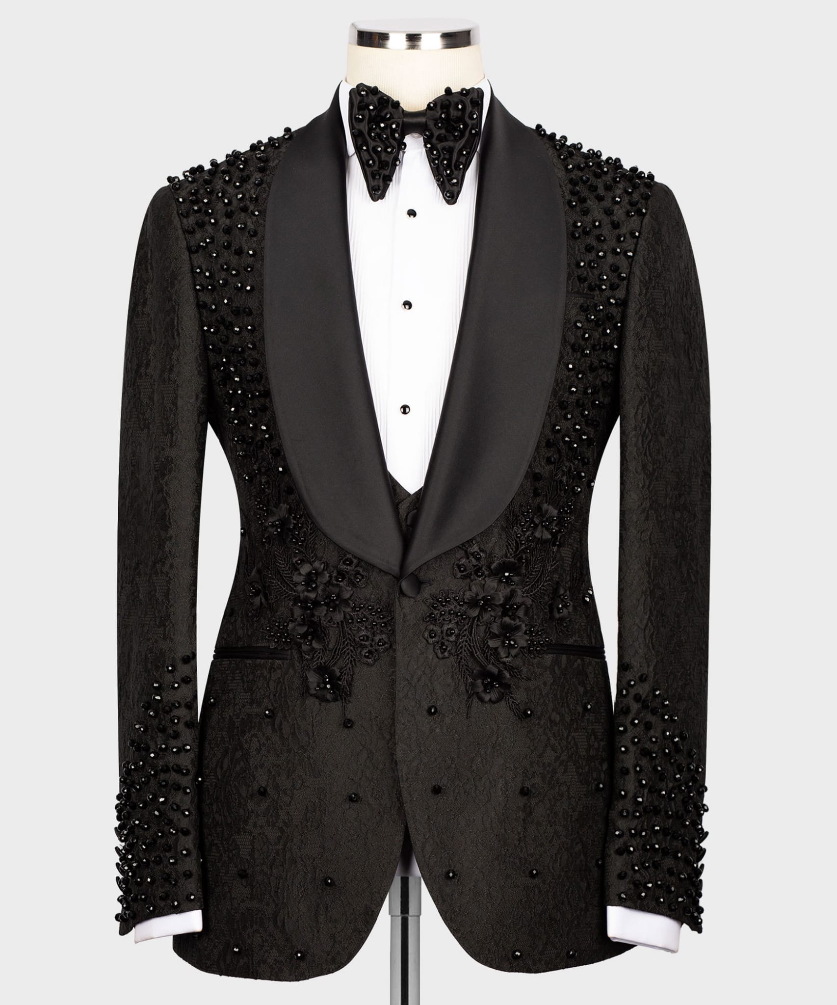 Black beaded tuxedo jacket on a mannequin against a white background