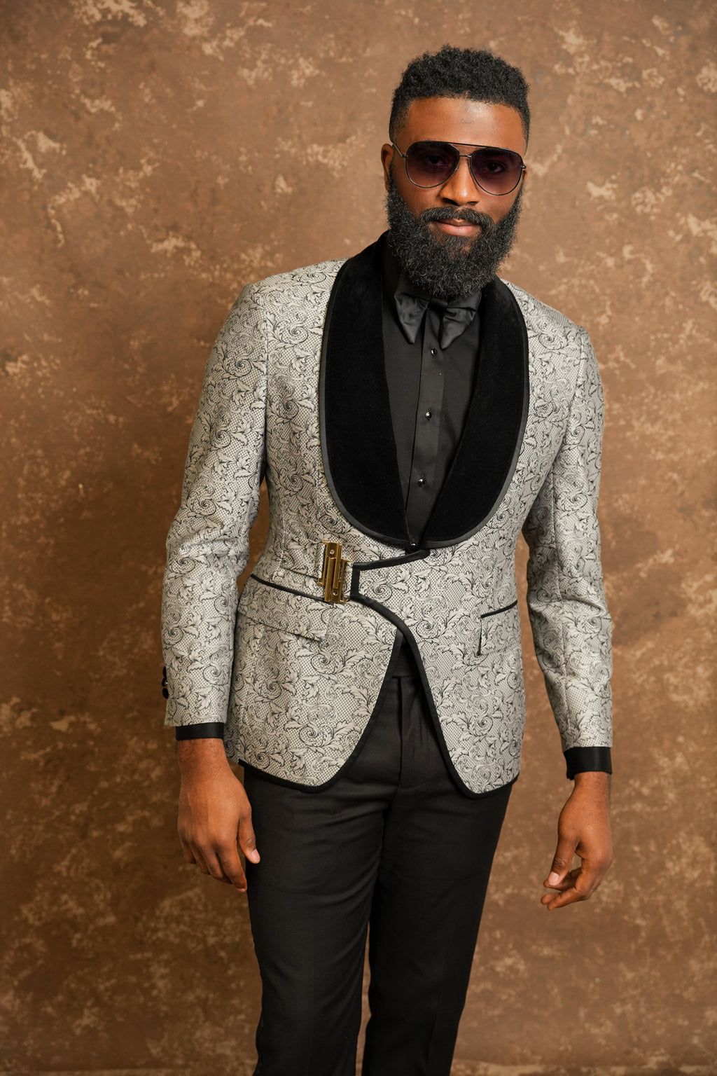 Man wearing a gray patterned tuxedo with a black tuxedo shirt