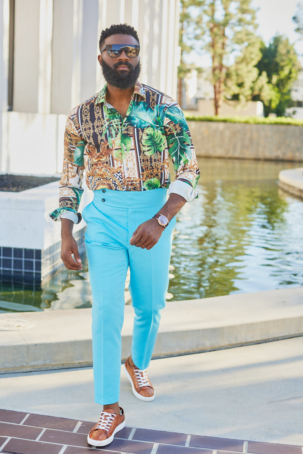 a man wearing a green tulum floral shirt shirt