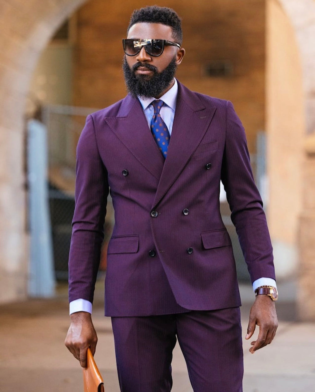A well groomed man in The Hitchson Double Breasted Suit with matching purple trousers